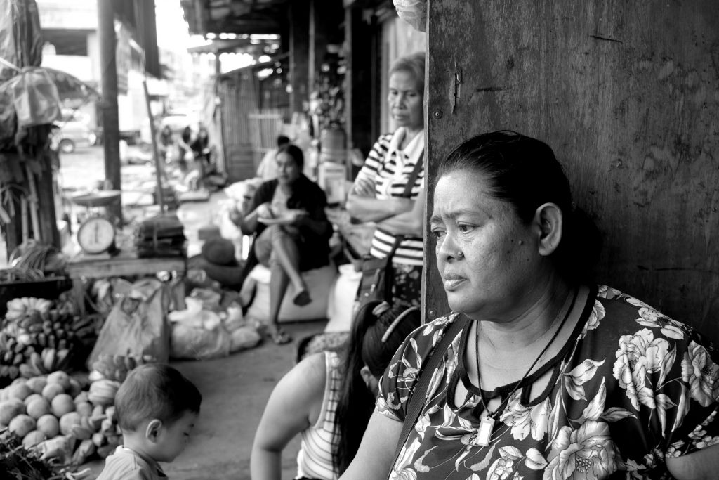 THE OTHER SIDE. The streets may have been cleared but Elizabeth Villacampa is confused as to where to get the next meal as her street vending had been affected. |Photo by Lourdes Rae Antenor, text by Julius D. Mariveles
