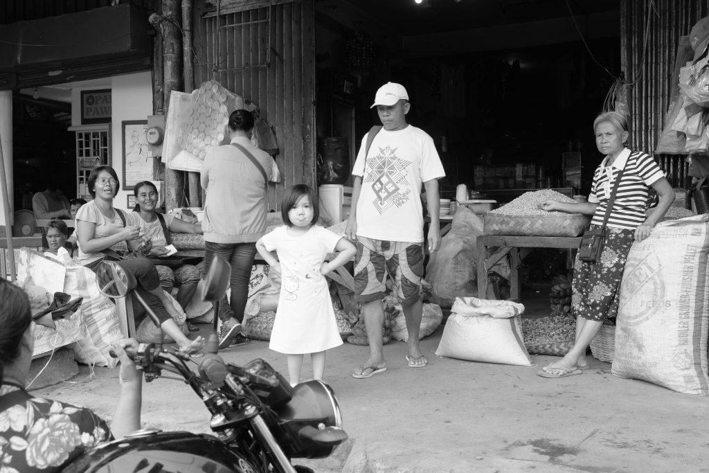 JUST DARE. A young daughter of a market vendor owning this stall along Amelia Avenue at the South or Libertad Public Market makes a defiant gesture at the photographer. This child has seen the demolition of illegal structure for days at Amelia. |Photo by Lourdes Rae Antenor, text by Julius D. Mariveles