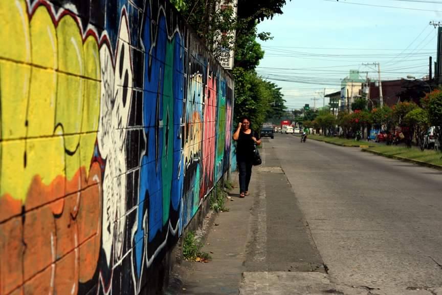 WALL, WOMAN, WIDE EMPTY ROAD. Burgos Street, May 16, 2011. | Photo by Julius D. Mariveles