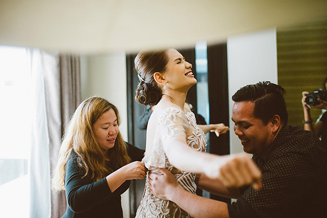 The designer, here helping a client into his design, is a former biologist who opted to go full-designer. Photo courtesy of Junriz Henderin
