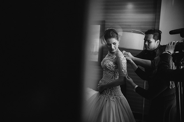Final touches. The designer helps with the finishing touches to ensure that not a hair, single bead, or a strand of lace is out of place. Photo courtesy of Junriz Henderin.
