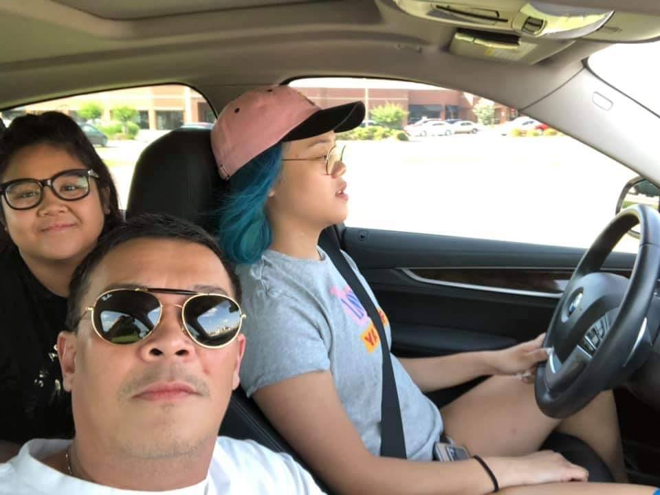Bacoleño Carlo Sales with his daughters, Veronika Gwen, driving, and Charlize Margaret, in back with glasses. | Photo courtesy of Carlo Sales from his Facebook personal collection.