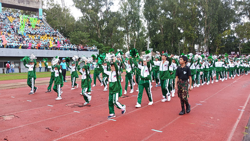 A roaring welcome to the Bacolod city athletic delegation as they wave their green and white pom poms as a response to the huge crowd support during the opening ceremony of The 2019 Palarong Panlalawigan at the Panaad Park and Stadium. | Photo by Richard D. Meriveles