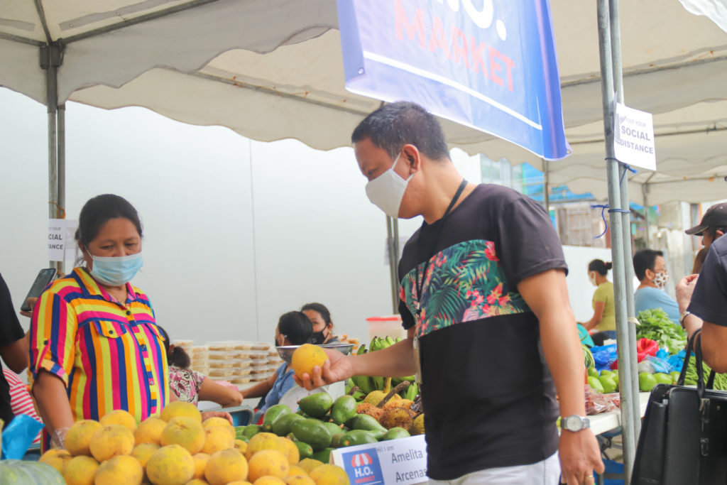 Jesus, NWTF staff, checks out fruit on display at the H.O. Market. | Photo by NWTF