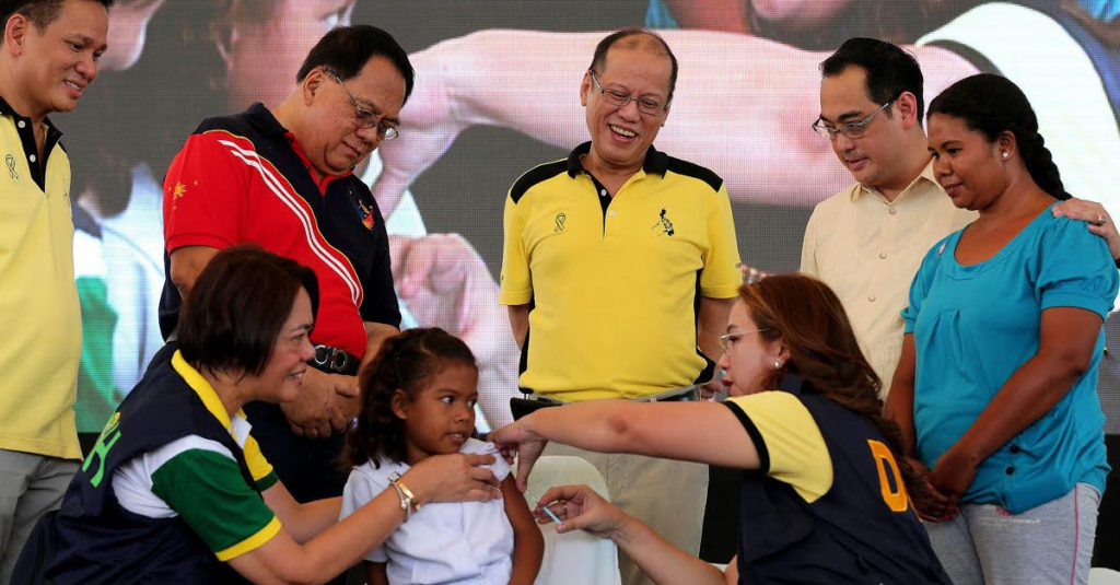 "President Benigno S. Aquino III, together with Interior and Local Government Secretary Mel Senen Sarmiento; and Zambales Governor Hermogenes Ebdane, Jr., witness the ceremonial vaccination of Dengue School-Based Immunization during the launching ceremony and ceremonial distribution of the Tamang Serbisyo Para sa Kalusugan ng Pamilya (TSeKaP) Medical Equipment Package at the People Park in Poblacion, Iba, Zambales on Tuesday (April 05). Also in photo are Health Secretary Janette Garin and Zambales Governor Hermogenes Ebdane, Jr." by Malacañang Photo Bureau is in the Public Domain, CC0